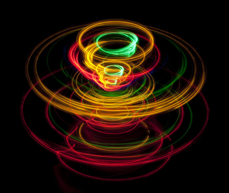 vivid lines of light tracing a pattern reminiscent of a spinning top toy