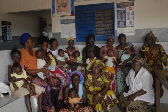 Awa Diagne (seated, far right) and her volunteer colleagues care for new mothers and infants.