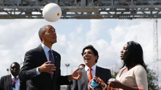Soccket co-founder, Jessica Matthews, right, shows off the Soccket with President Obama in Tanzania.