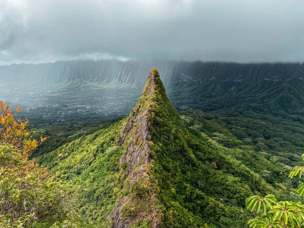 A verdant mountainous scene, showing volcanic rocks and Olomana Trail in Kailua, Hawaii.