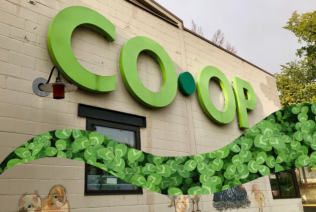 Cooperatives Image: A brick building with large green letters that read "Co-Op"