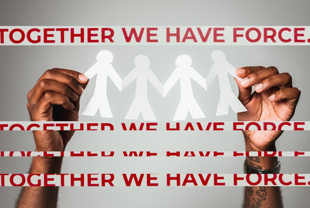 Work Centers Image: Two hands hold up paper cutout figures with text that reads "Together We Have Force"