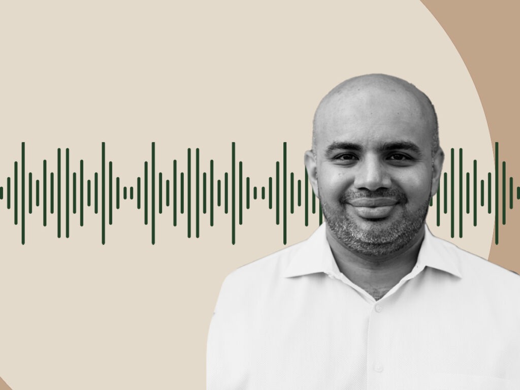 A black and white photo of speaker Saqib Bhatti on a tan background. There is a green sound wave behind him.