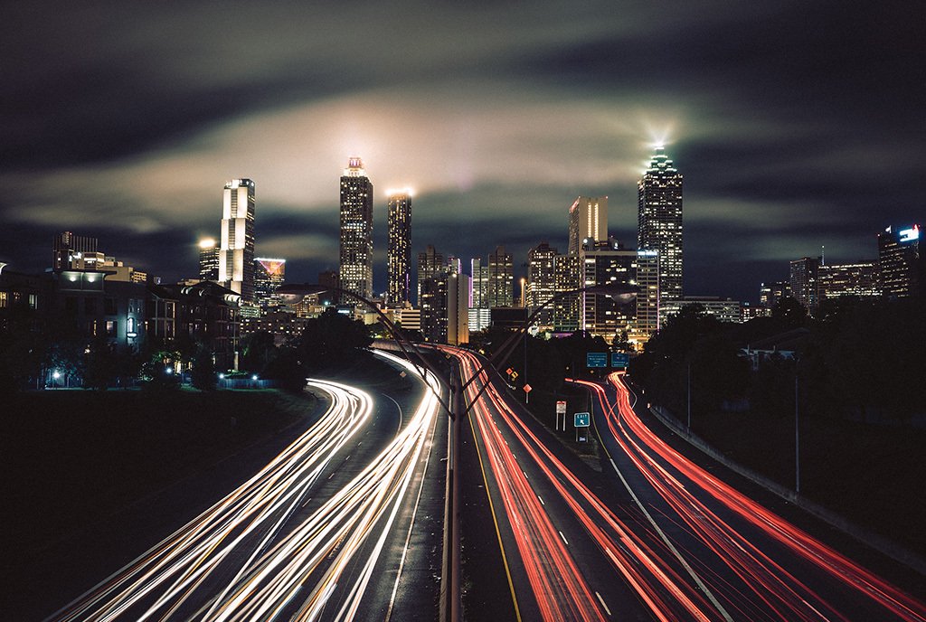 A nighttime photograph of Atlanta, showing the divided I-85 highway. To illustrate Racial Wealth Gap.