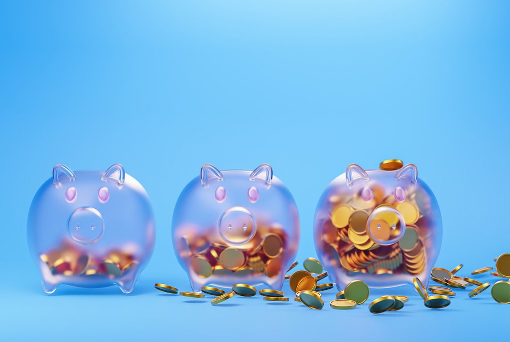Three piggy banks against a light blue background, with varying amounts of coins in them.