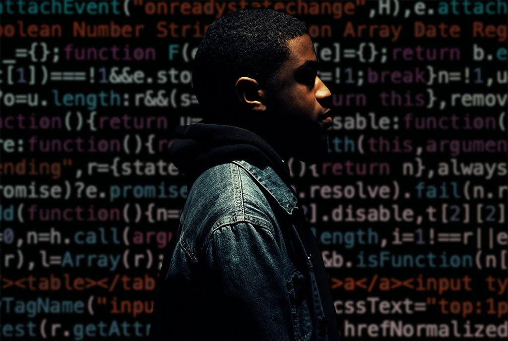 A Black Man in profile under a dim light, with colorful lines of coding behind him.