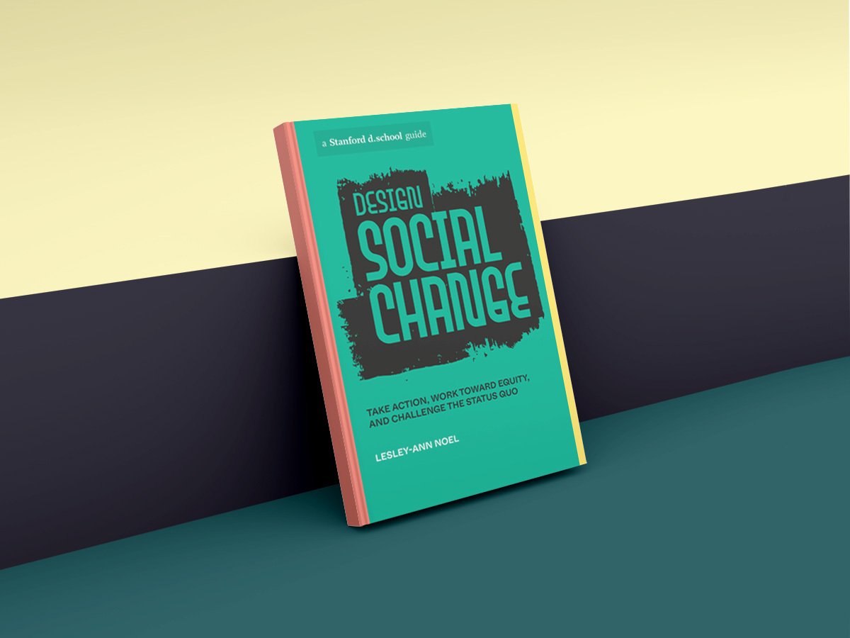 The author’s book, “Design Social Change: Take Action, Work toward Equity, and Challenge the Status Quo” leaning against a wall
