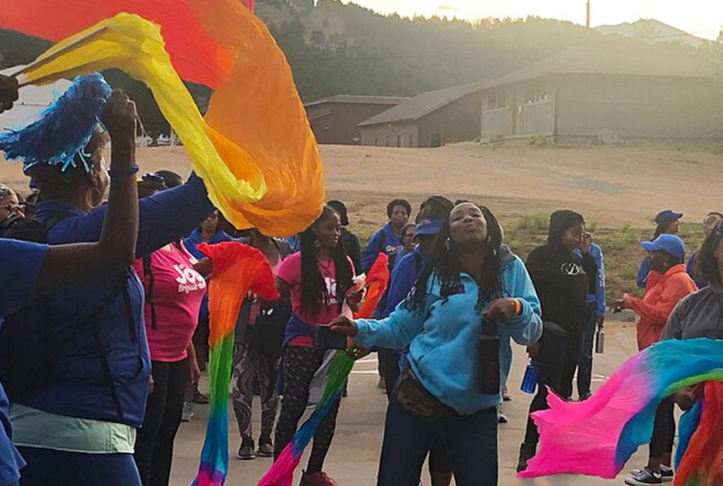 A group of Black GirlTrek celebrants ribbon dancing at GirlTrek's annual Stress Protest.