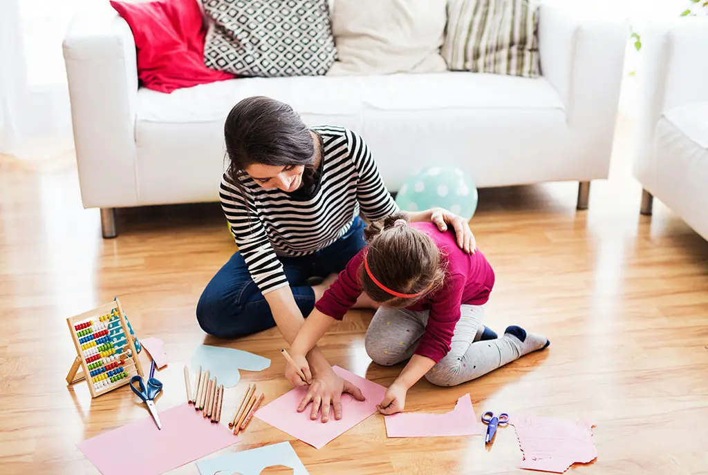 A woman providing at-home childcare for essential workers, common in the Long Beach pilot mentioned in the article.