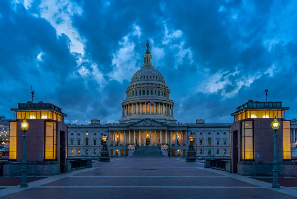 Photo of the United States Capitol at dusk with the lights turned on.