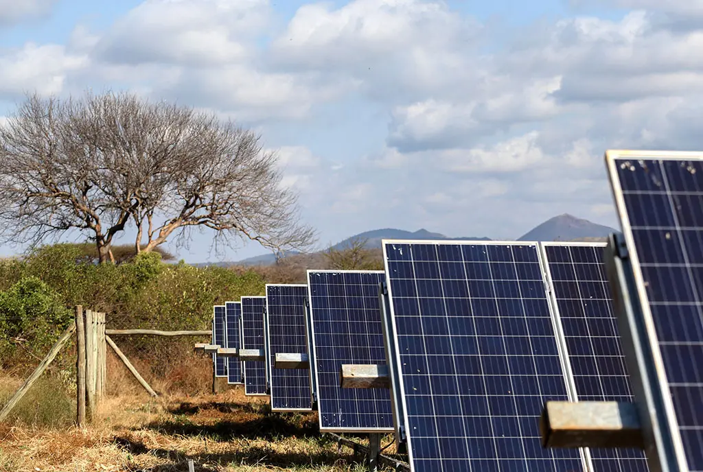 A solar panel farm in rural the West Kenyan landscape, representing renewable energy development in Africa.