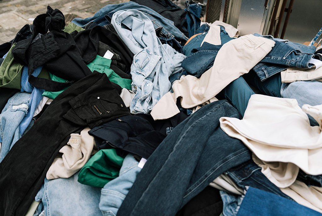 A heaping pile of donated clothes in the street, representing the used (and unusable and dirty) clothes donated in the wake of the LA fires.