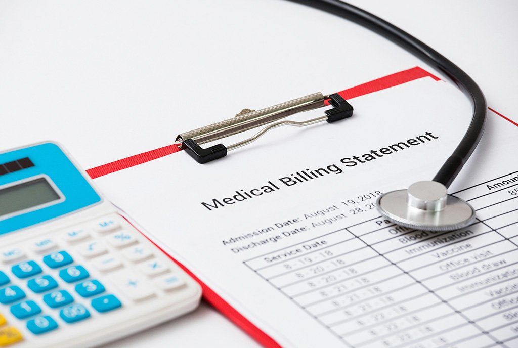 Layout of medical bill, calculator and stethoscope. It symbolizes the heavy debt that health care costs place on Americans.