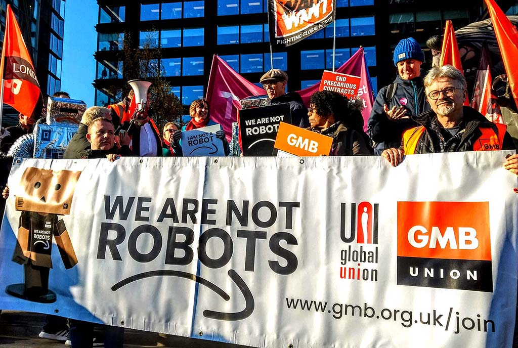 Workers gather together in protest to protest at Amazon’s headquarters, demonstrating the power of protesting at strategic corporate locations.