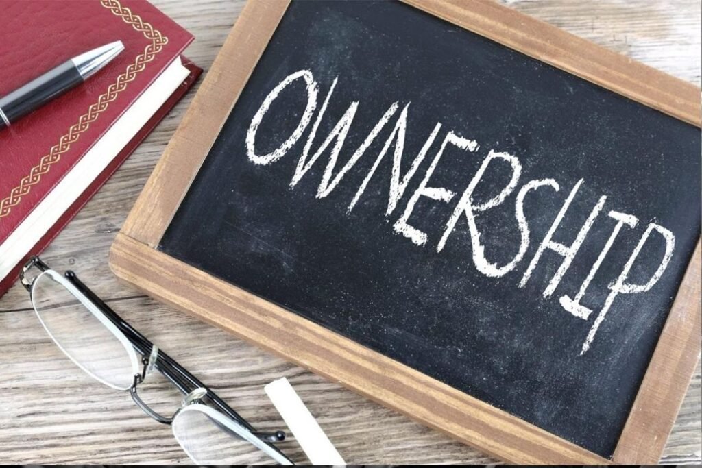The word OWNERSHIP is written in chalk in all capital letters on a chalkboard.
