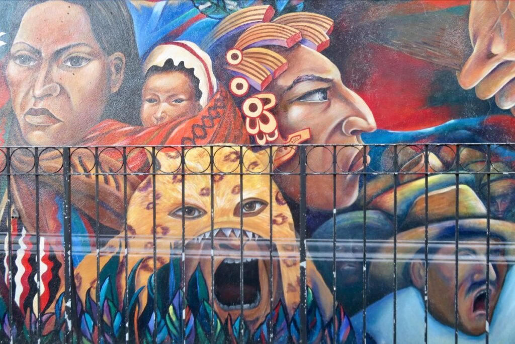 A mural in San Francisco’s Mission District displays Latino and Latina marchers as well as a tiger in the foreground.