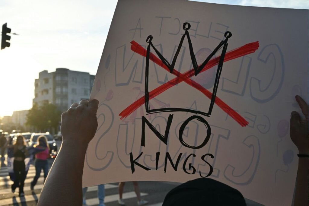 A protest sign that reads “No Kings” with a red X through a drawing of a crown.