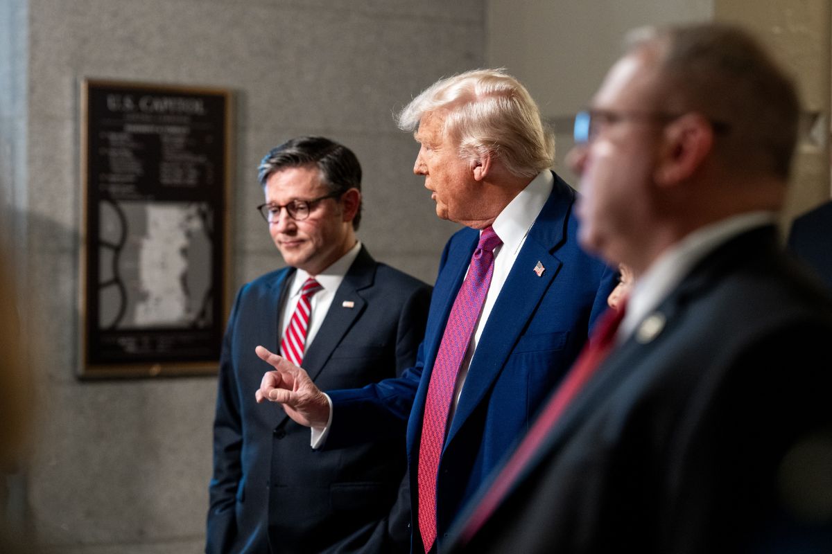 President Donald Trump Speaker of the House Mike Johnson in conversation in a hallway.