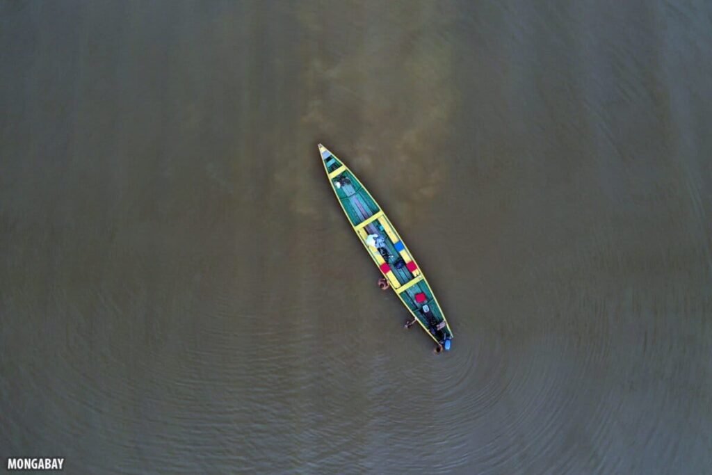 Aerial shot of a colorful canoe in an Amazonian lake.