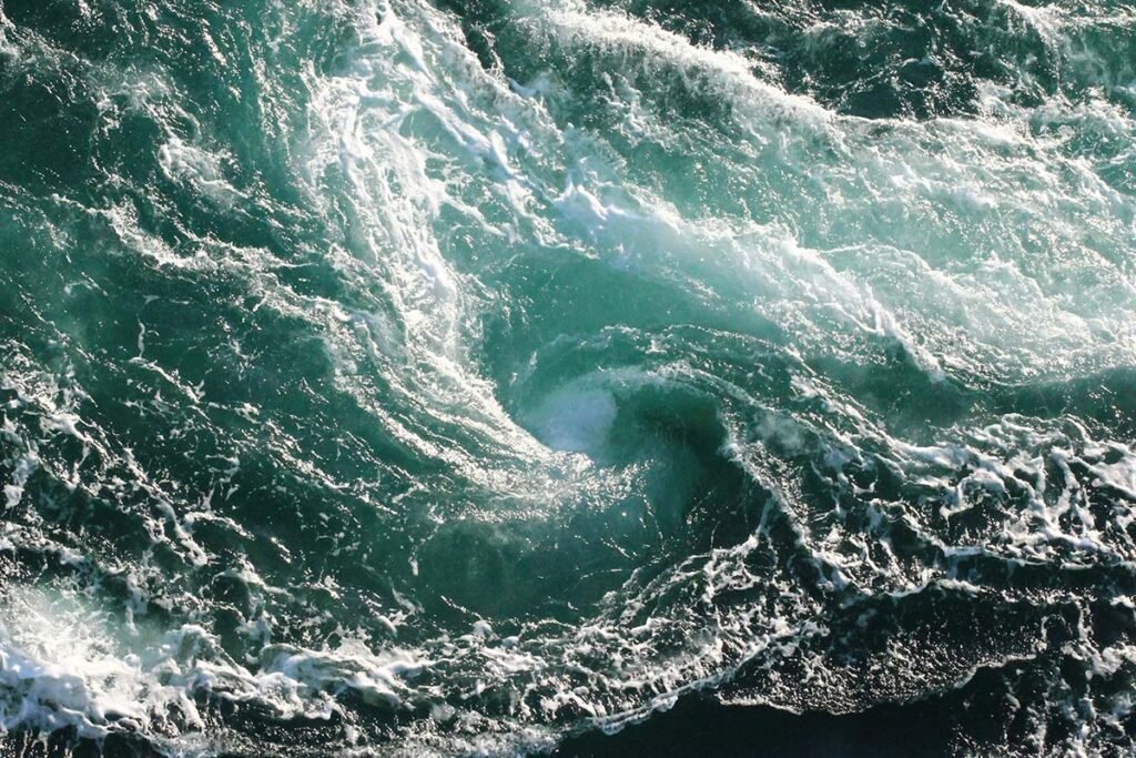 A maelstrom with swirling oceanic waters, representing the political hostility and economic turbulence nonprofits face.