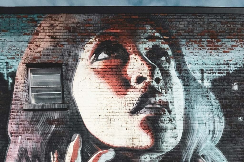A mural of an Indigenous woman looking up towards the sky, symbolizing vision and hope. Montréal, QC, Canada.
