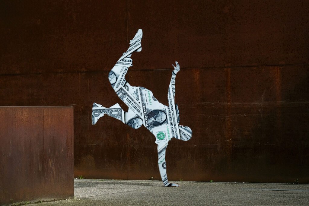 A composition of a person break dancing, who is superimposed with $1 bills.