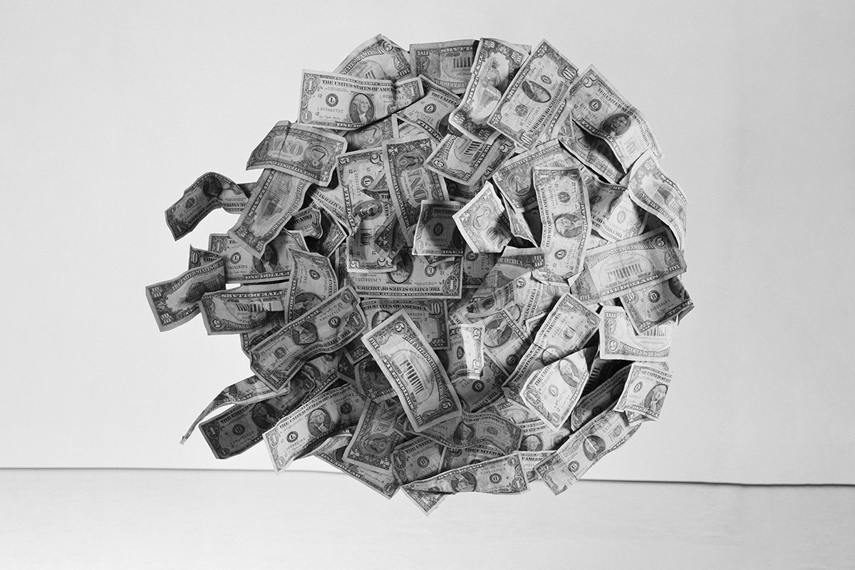A floating ball of dollar bills, symbolizing the organization and control of money.