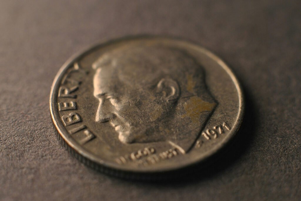 a dime, representing small amount of money that are dedicated to volunteers for every $100 donated.