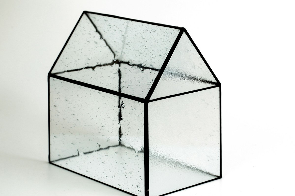 A glass model of a house, representing a shared and transparent container for decision making.