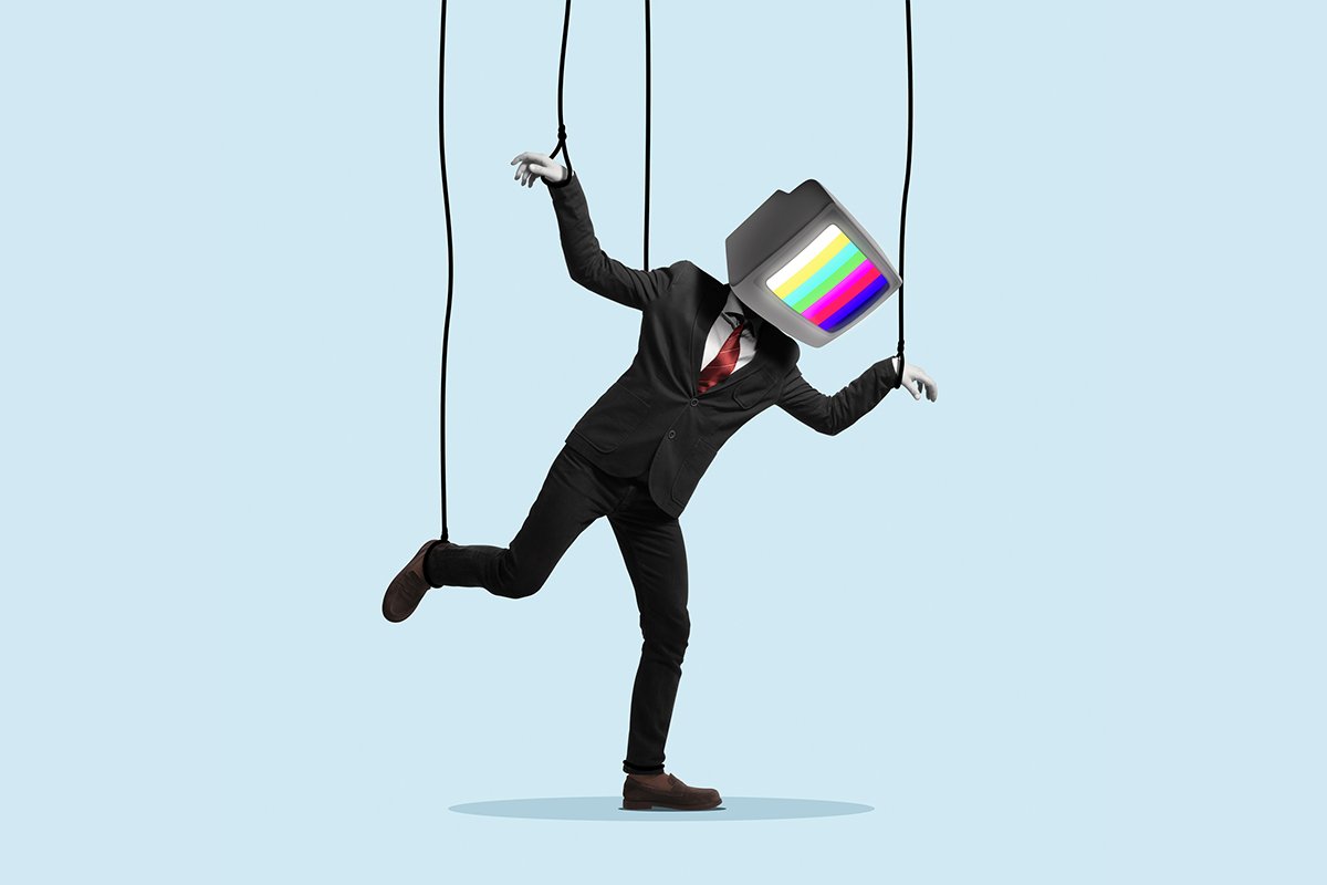 A man in a business suit with a television for a head, his arms and legs are being controlled by puppet strings.