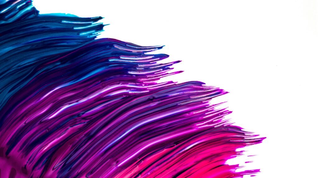 Textured blue, purple, and magenta paint bands flow up from the bottom left corner of the image, stopping in the middle of the frame. The top right half of the image is blank white.