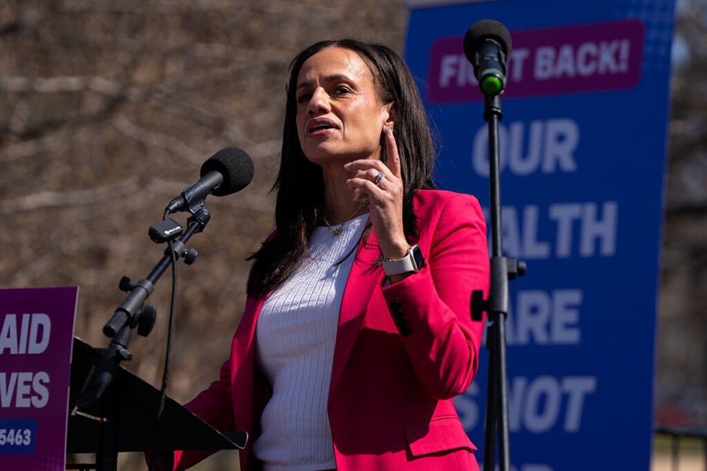 Alexis McGill Johnson, president and CEO of Planned Parenthood Federation of America, at a podium on a stage. She is a brown-skinned woman with brown hair wearing a pink suit jacket. Washington DC on March 12, 2025