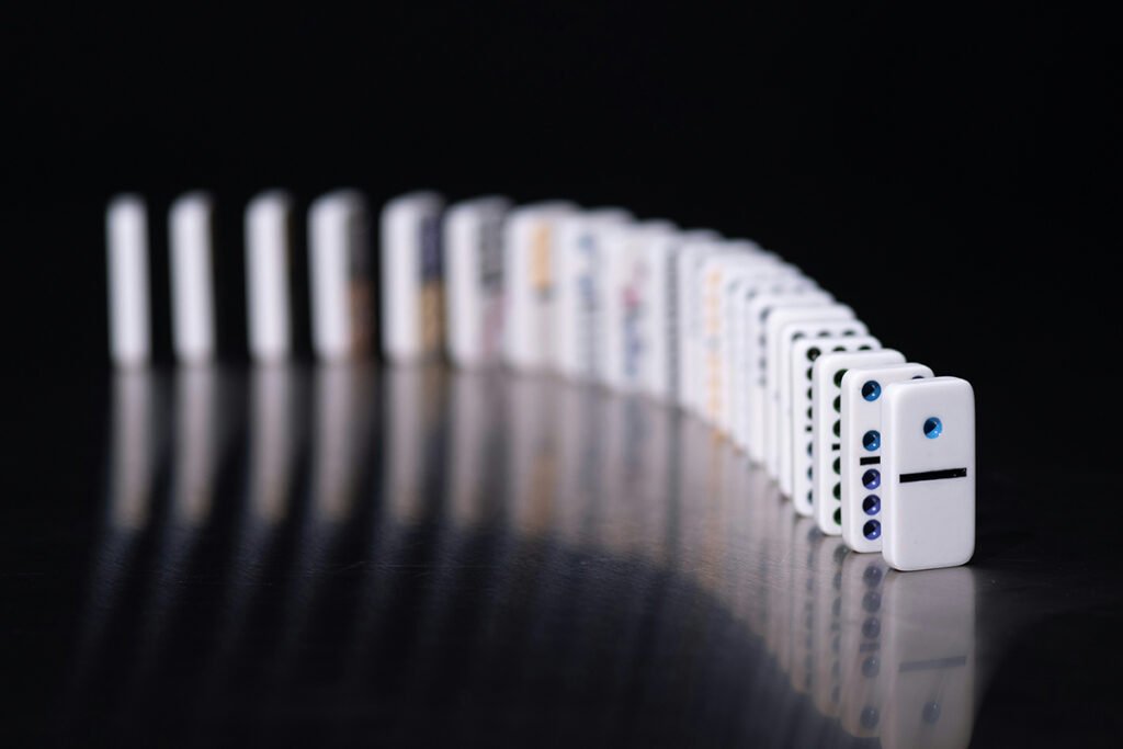 An arrangement of aligned domino pieces ready to topple at any moment.