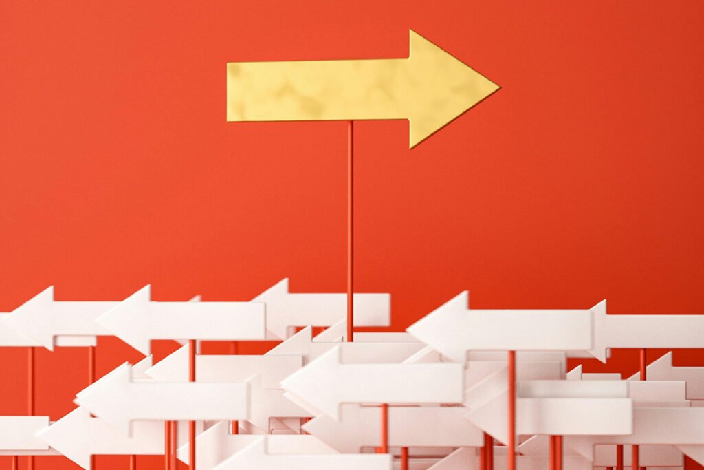 A large yellow arrow pointing to the right rises above a sea of smaller white arrows pointing to the left.