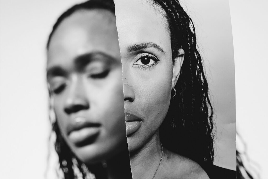 A black and white photo of a Black woman with braids with her eyes closed. The image is superimposed with a ripped image of the same woman looking directly at the viewer.