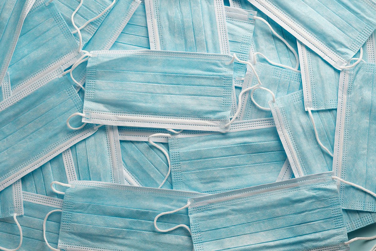 A pile of disposable blue respiratory face masks.