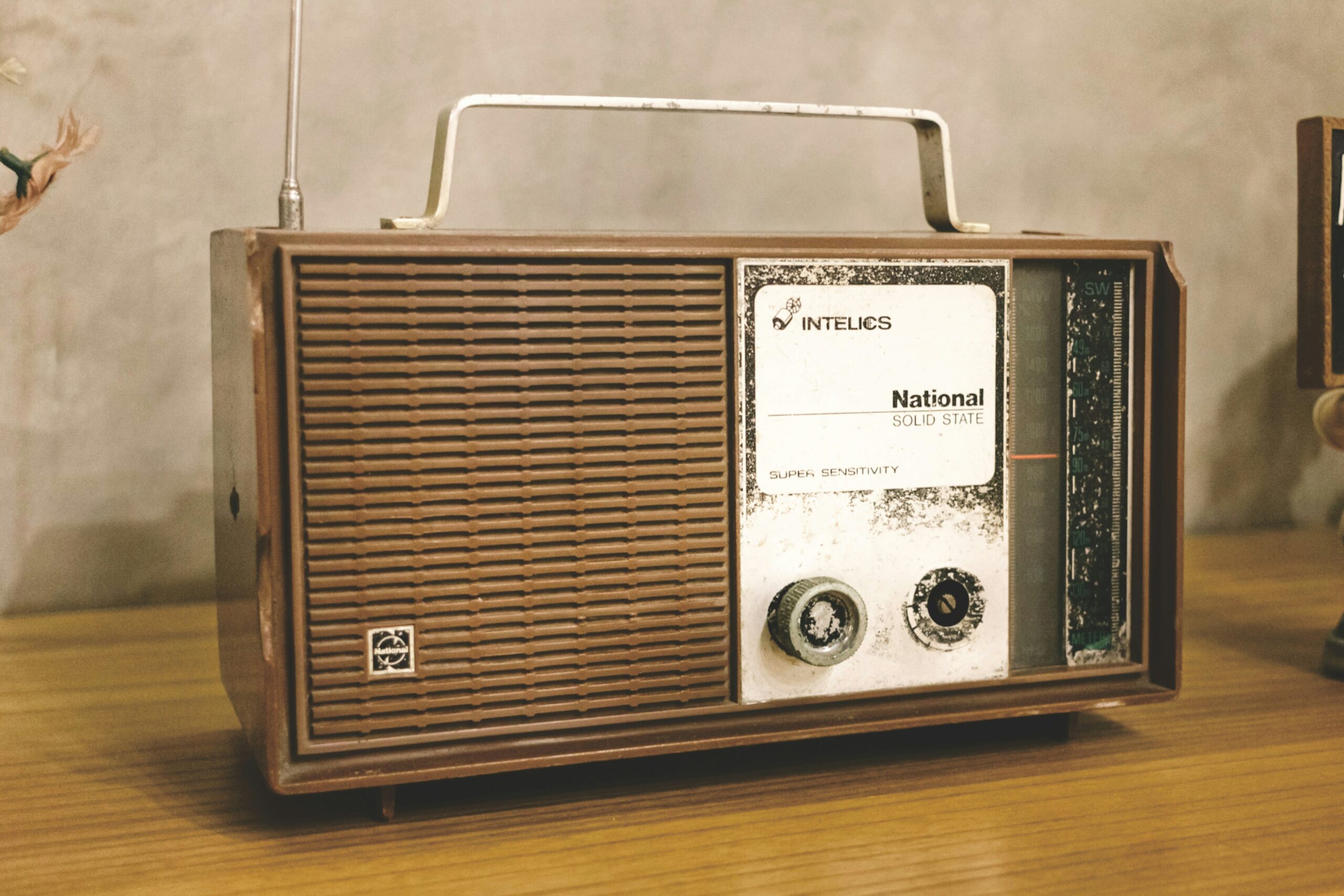 A vintage radio atop a wooden table.