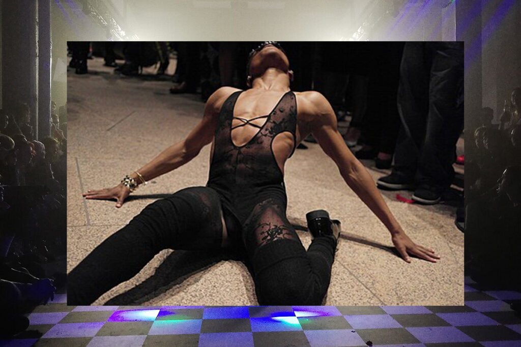 An image of a Black person in drag attire vogueing on the floor of a ballroom. Superimposed over a ballroom arena.