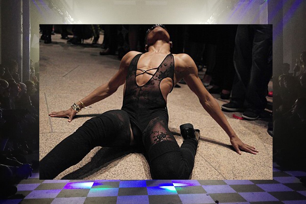 An image of a Black person in drag attire vogueing on the floor of a ballroom. Superimposed over a ballroom arena.