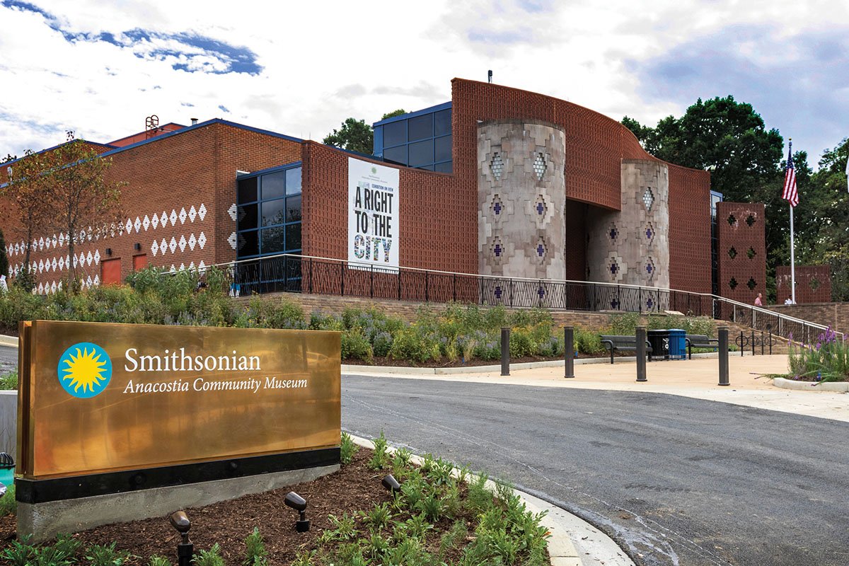 The Anacostia Community Museum in Washington, DC, a red brick building with white diamond patterns in the brick.