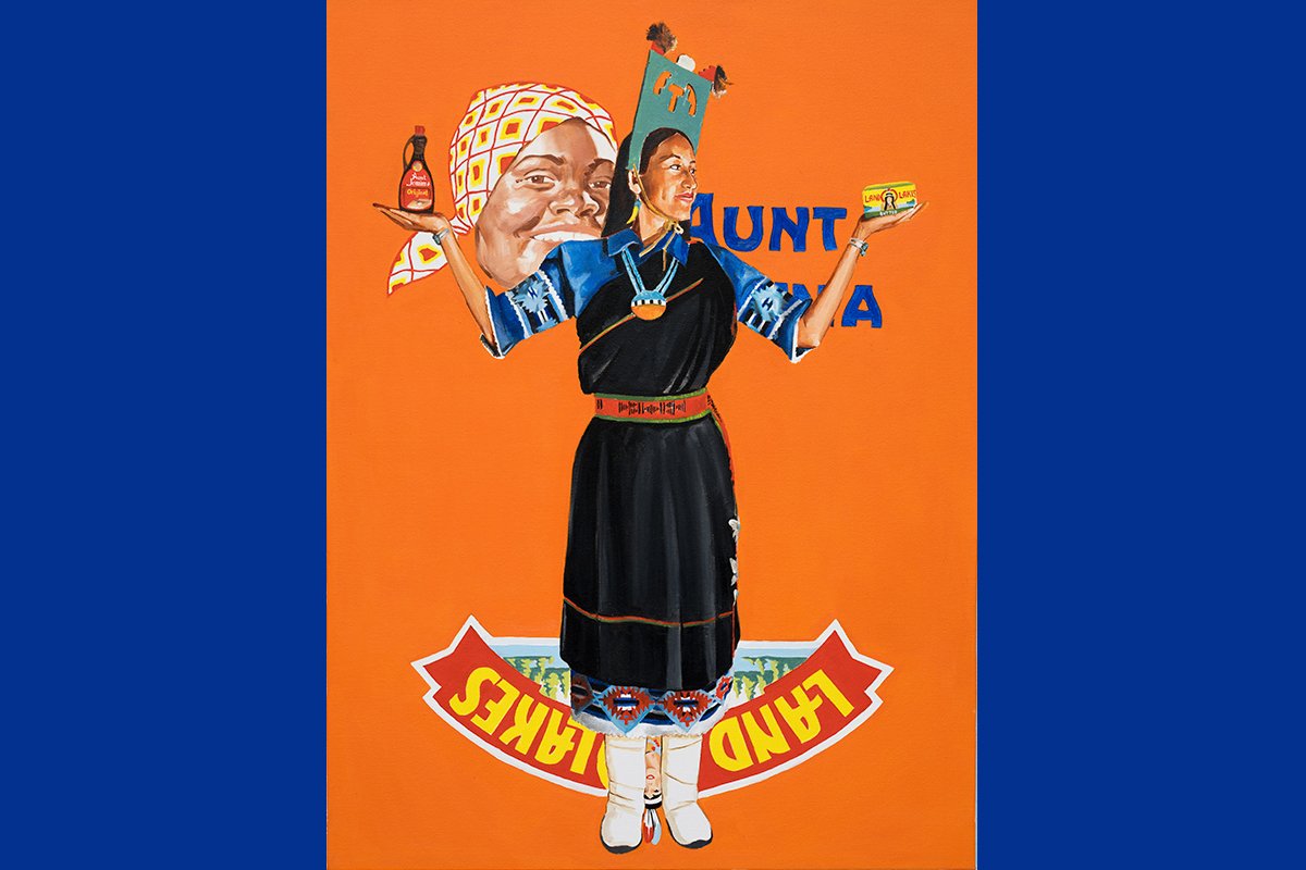 A painting of a woman holding Aunt Jemima’s syrup in one hand and Land’O’Lakes butter in the other hand as she stands in profile. She wears traditional native Jemez Pueblo attire.