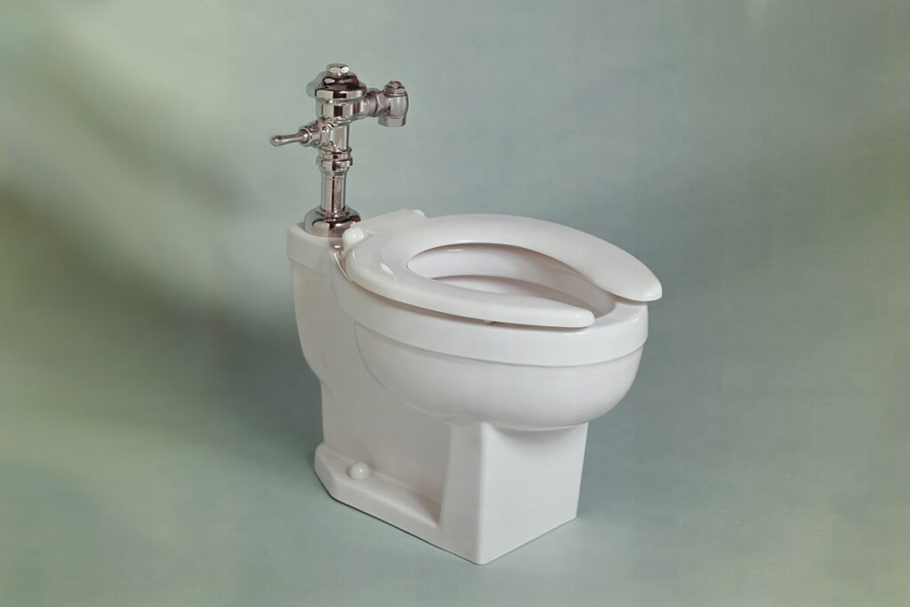 A solitary white toilet in an empty room.