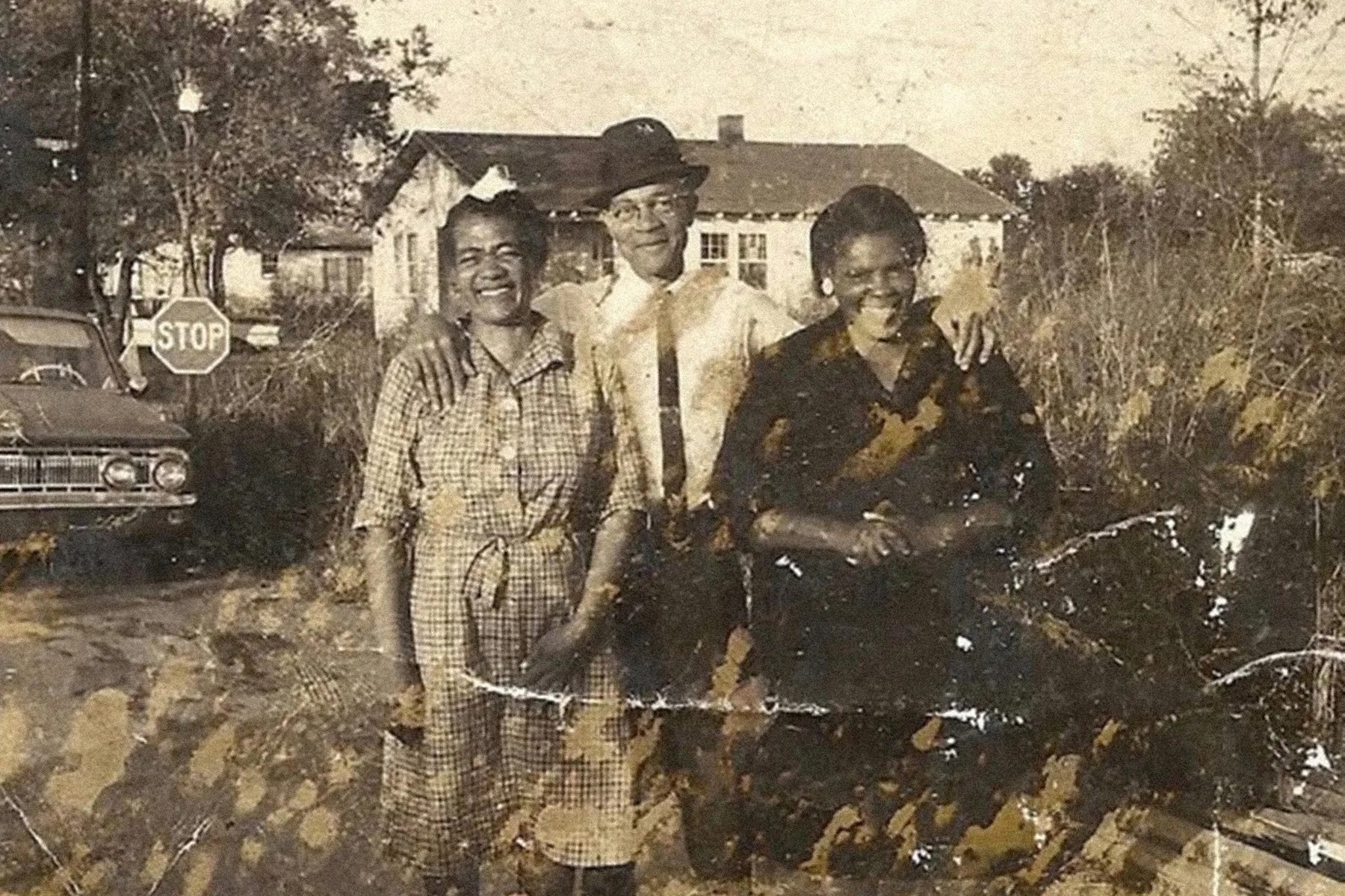 LaTosha Brown's grandparents, Joseph and Nellie Gamble (left), taught her the value of voting by bringing her with them to the polls to cast their vote. Alt text: A yellowing printed photograph of three Black people smiling at the camera.