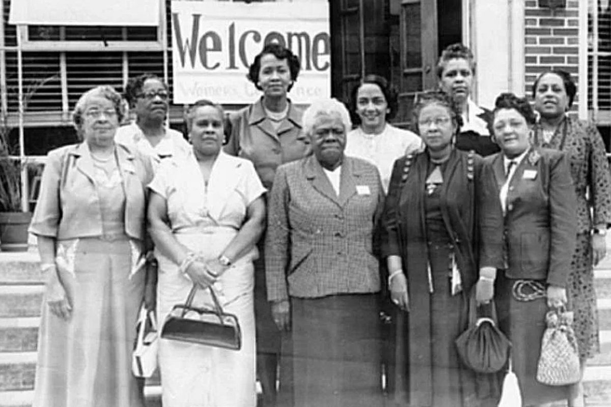 A grainy, black and white photo of ten smartly dressed women, the officers of the National Council of Negro Women. Founder Mary McLeod Bethune is at center.