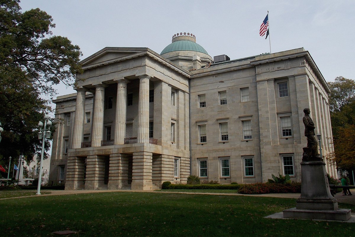 North Carolina’s state capitol building, a stone, rectangular building with four columns and a dome on top. Raleigh, North Carolina.