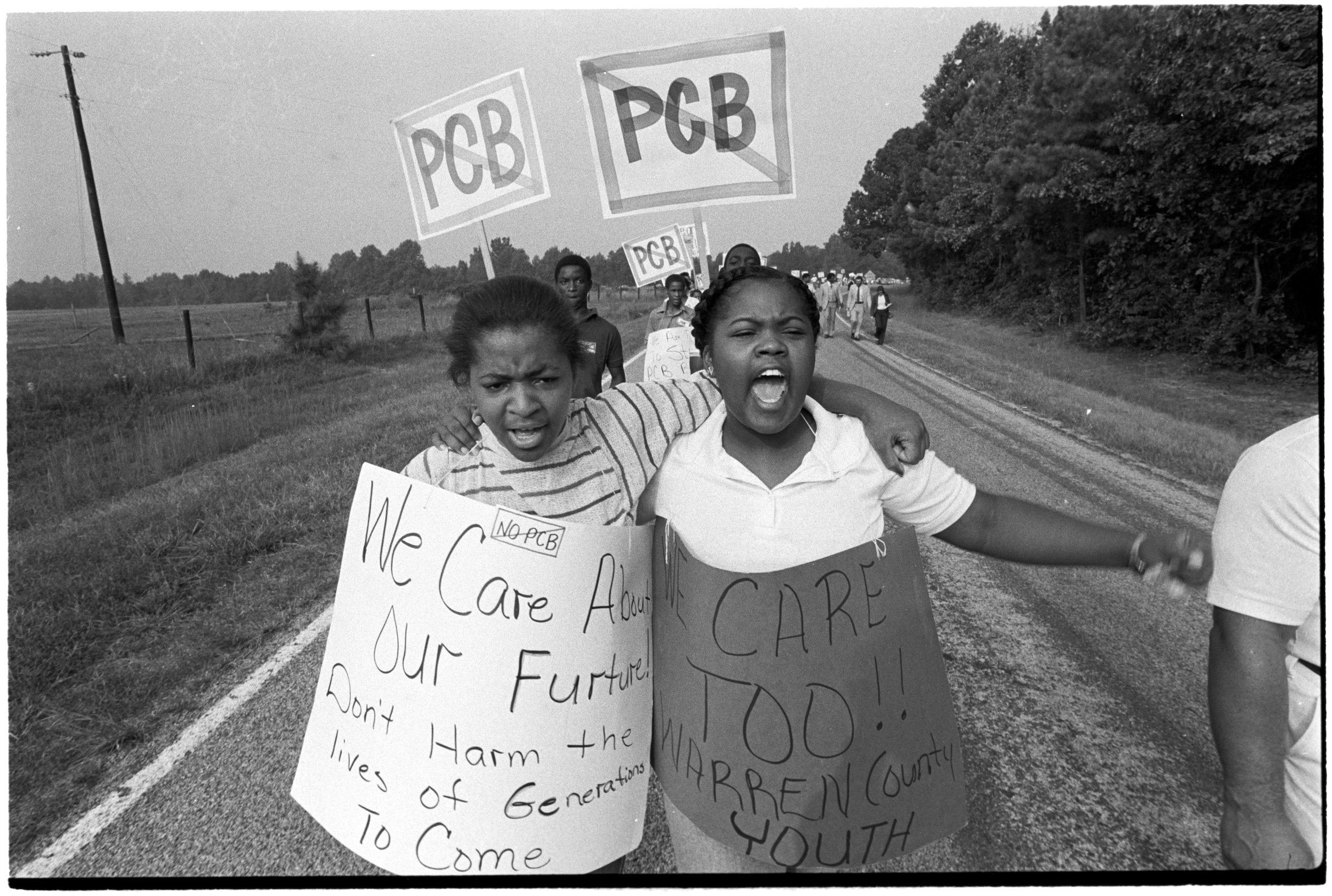 For six weeks in 1982, activists and residents, such as then-15-year-old Consherto Williams (on the right), gathered in Warren County, near the town of Afton, to protest the delivery of 40,000 cubic tons of contaminated soil laced with polychlorinated biphenyls (PCBs), to the hazardous waste landfill in their community. The PCBs would eventually leach into the ground and contaminate the water supply. Credit: The Jerome Friar Photographic Collection and Related Materials, Wilson Library, UNC-Chapel Hill, used with permission.