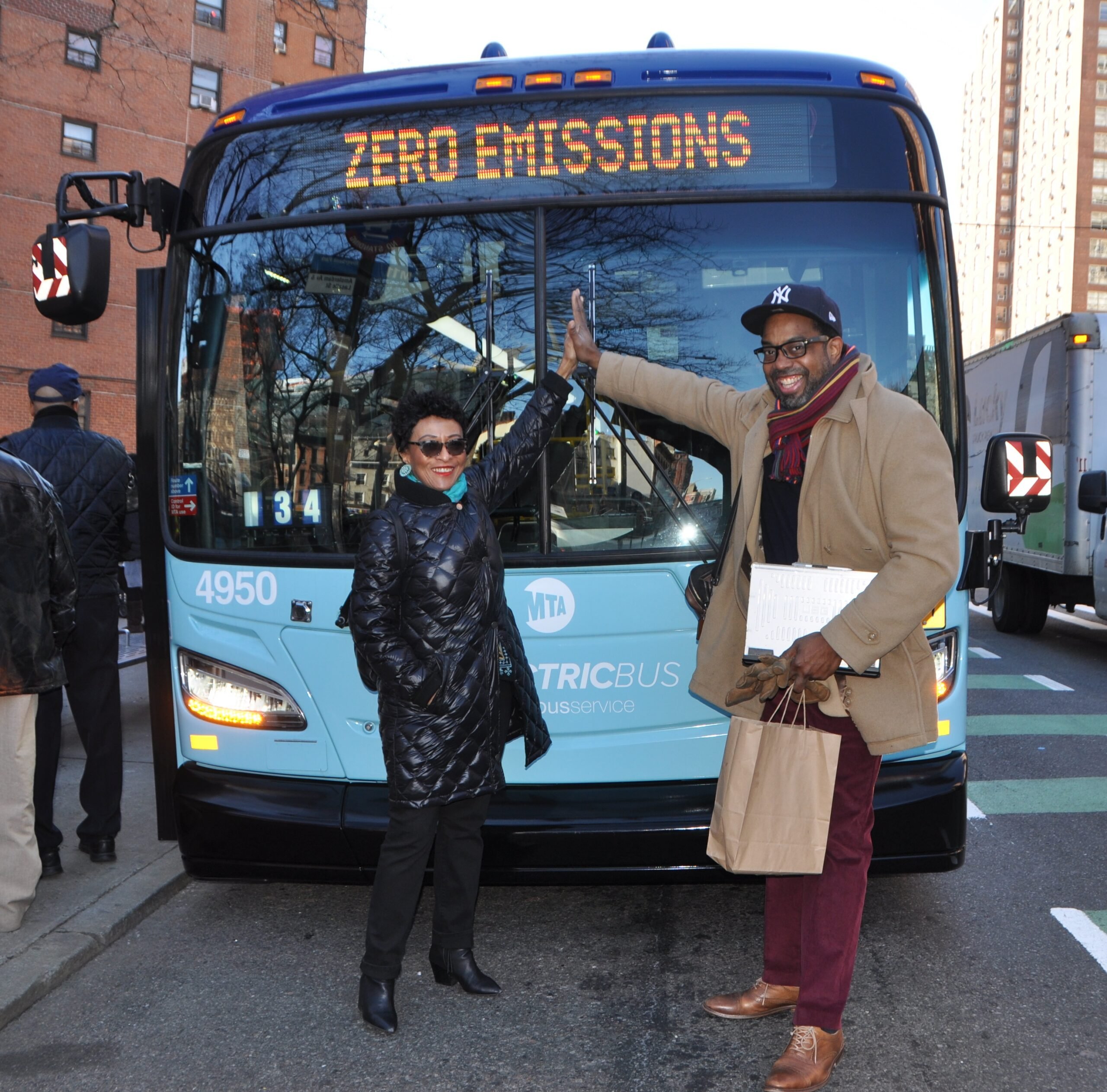 Peggy Shepard (left) and the late Cecil Corbin-Mark (right), WE ACT's Deputy Director, celebrate the first electric bus in Harlem.