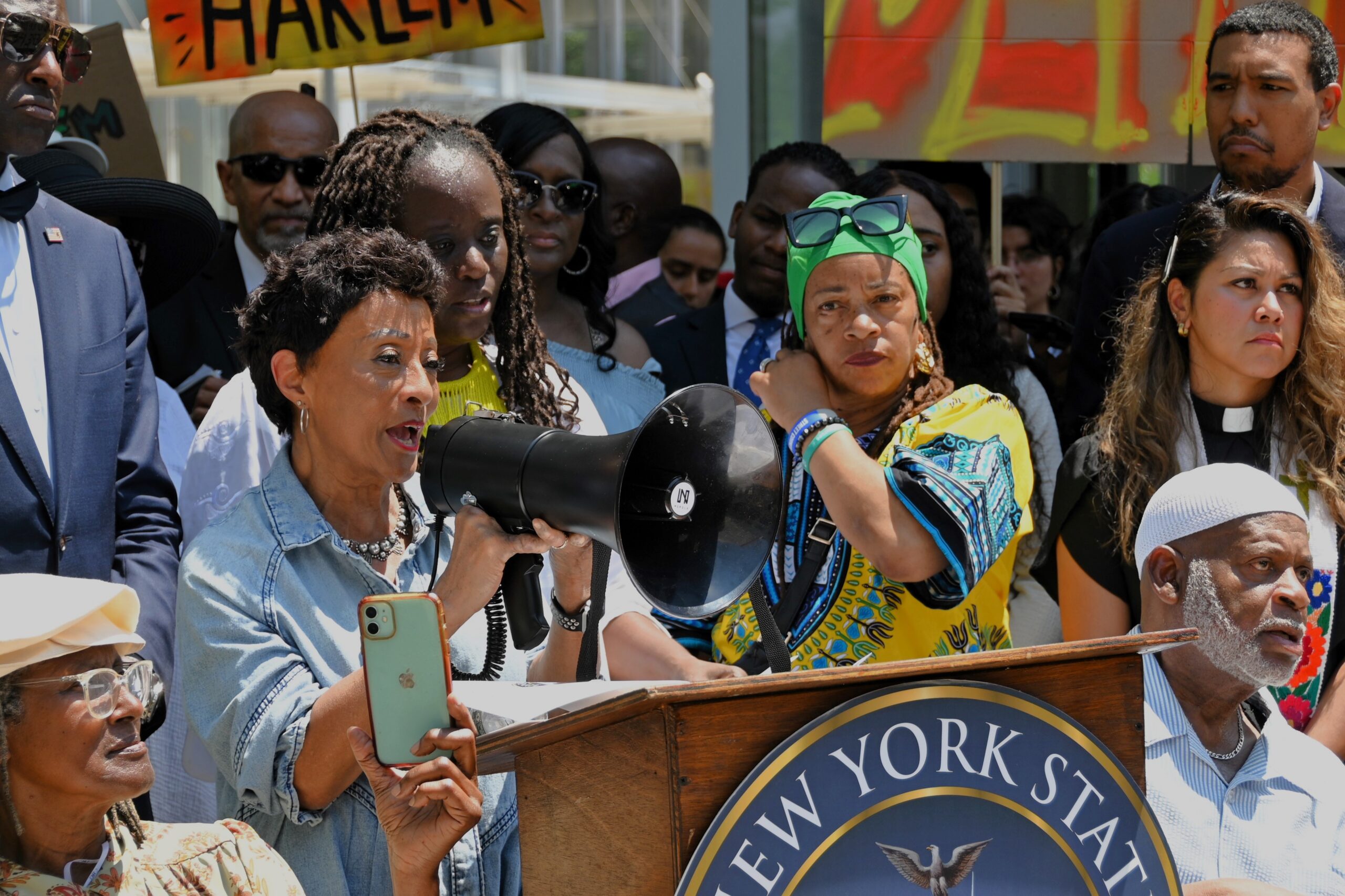 Peggy Shepard speaking at a rally to keep Harlem affordable, alongside New York State Senator Cordell Cleare and others.