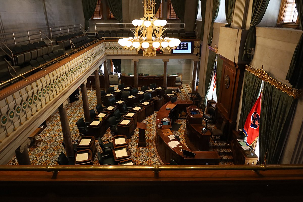 The inside of the Senate Chamber in the Tennessee State Capitol, a large room with a balcony and wooden furniture.