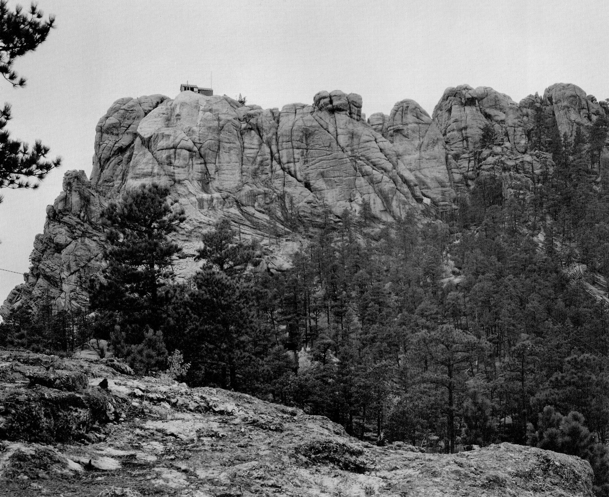The Six Grandfathers before construction of Mount Rushmore was complete. The face of George Washington is first beginning to appear (top left), c. 1930s. Bill Groethe.